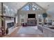 Inviting living room with vaulted ceilings, a fireplace, and a large TV at 480 Firelite Ln, Suwanee, GA 30024