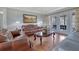 Elegant living room featuring hardwood floors, a tufted leather sofa, and French doors at 480 Firelite Ln, Suwanee, GA 30024