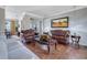 Elegant living room with hardwood floors, tufted couches, and decoratively appointed lighting at 480 Firelite Ln, Suwanee, GA 30024
