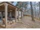 Cozy covered patio with outdoor furniture, ceiling fan, and wooded view at 480 Firelite Ln, Suwanee, GA 30024