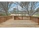 Spacious wooden back deck overlooking a treed lot and natural landscape at 5960 Magnolia Rdg, Stone Mountain, GA 30087