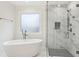 Spa-like bathroom featuring a freestanding tub and a frameless glass shower with rainfall showerhead at 5960 Magnolia Rdg, Stone Mountain, GA 30087