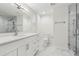 Bathroom features a glass enclosed shower, tile floor, white vanity and brushed nickel hardware at 5960 Magnolia Rdg, Stone Mountain, GA 30087