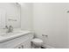 Half bathroom with white vanity, modern sink and faucet, toilet, mirror, and neutral wall color at 5960 Magnolia Rdg, Stone Mountain, GA 30087