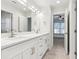 Bright bathroom with double vanity sinks and a view to the adjacent bedroom space at 5960 Magnolia Rdg, Stone Mountain, GA 30087