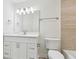 Well-lit bathroom featuring a vanity with storage, a decorative mirror and a toilet at 5960 Magnolia Rdg, Stone Mountain, GA 30087