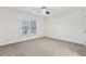 Bright bedroom with neutral carpet, a ceiling fan and a window letting in natural light at 5960 Magnolia Rdg, Stone Mountain, GA 30087