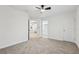 Well-lit bedroom with neutral decor and ceiling fan features a carpeted floor and direct access to bathroom at 5960 Magnolia Rdg, Stone Mountain, GA 30087