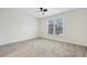 Bright bedroom with a ceiling fan, a carpeted floor and a window overlooking the neighborhood at 5960 Magnolia Rdg, Stone Mountain, GA 30087