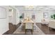 Elegant dining room with a chandelier, coffered ceilings, hardwood floors and ample natural light, perfect for entertaining at 5960 Magnolia Rdg, Stone Mountain, GA 30087