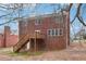 Two story brick house with a wooden deck and stairs, surrounded by leafless trees at 5960 Magnolia Rdg, Stone Mountain, GA 30087