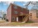 Two-story brick house with a wooden deck and stairs leading to the backyard at 5960 Magnolia Rdg, Stone Mountain, GA 30087