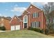 Charming two-story brick home with a two-car garage, manicured lawn and attractive front door at 5960 Magnolia Rdg, Stone Mountain, GA 30087
