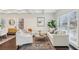 Elegant living room with coffered ceilings, large windows, hardwood floors and comfortable seating arrangements at 5960 Magnolia Rdg, Stone Mountain, GA 30087