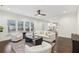 Bright and airy living room featuring large windows, hardwood floors and a cozy seating arrangement at 5960 Magnolia Rdg, Stone Mountain, GA 30087