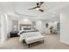 Spacious main bedroom with tray ceiling, fan, and seating area at 5960 Magnolia Rdg, Stone Mountain, GA 30087