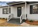 Charming home entrance with a decorative front door and fresh landscaping at 1210 Beech St, Marietta, GA 30062