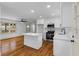 Open kitchen layout with a white island, stainless steel appliances, and hardwood floors at 1210 Beech St, Marietta, GA 30062