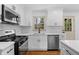 Modern kitchen featuring white cabinets, stainless steel appliances, and subway tile backsplash at 1210 Beech St, Marietta, GA 30062