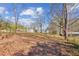 A view of a wooded backyard and a home in a private setting at 5450 Frazer Rd, Buford, GA 30518
