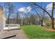 Expansive backyard boasts a large grass area and a raised white deck, perfect for outdoor enjoyment at 5450 Frazer Rd, Buford, GA 30518