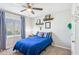 Cozy bedroom boasts a comfortable bed, bright blue accents, and a window with natural light to create a relaxing retreat at 5450 Frazer Rd, Buford, GA 30518