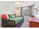 Stylish bedroom features decorative wall art, a daybed, and a window providing natural light and a serene view at 5450 Frazer Rd, Buford, GA 30518