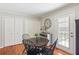 Charming breakfast nook features hardwood floors, classic decor, and ample natural light from the sliding door at 5450 Frazer Rd, Buford, GA 30518