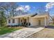 Charming single-story home with white brick, a covered carport, and a well-maintained lawn at 5450 Frazer Rd, Buford, GA 30518
