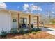 Inviting front porch with seating area, a wreath on the door, and a covered carport at 5450 Frazer Rd, Buford, GA 30518