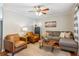 Cozy living room with stylish furnishings, a ceiling fan, and a decorative coffee table at 5450 Frazer Rd, Buford, GA 30518
