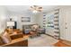 Bright living room featuring hardwood floors, a gray sofa, and striped curtains at 5450 Frazer Rd, Buford, GA 30518