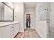 Modern bathroom with double vanity, walk-in closet, and glass shower at 66 Rogers Ne St, Atlanta, GA 30317