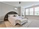 Spacious bedroom with a large bed, bench, and large windows for natural light at 66 Rogers Ne St, Atlanta, GA 30317