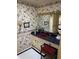 Cozy bathroom with vibrant floral wallpaper, red sink, and tiled countertop at 217 Shields Rd, Stockbridge, GA 30281
