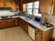 Traditional kitchen with wooden cabinets, light countertops, and a window overlooking the yard at 217 Shields Rd, Stockbridge, GA 30281