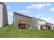 Backyard and deck of a two-story gray home with a lush green lawn at 61 Okeechobee Way, Braselton, GA 30548
