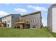 Backyard and deck of a two-story gray home with a sliding glass door at 61 Okeechobee Way, Braselton, GA 30548