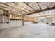 Unfinished basement featuring exposed ceiling beams and natural light through the door at 61 Okeechobee Way, Braselton, GA 30548