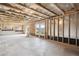 Unfinished basement featuring exposed ceiling beams and large windows at 61 Okeechobee Way, Braselton, GA 30548