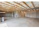 Unfinished basement shows exposed ceiling beams and concrete foundation at 61 Okeechobee Way, Braselton, GA 30548
