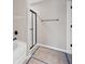 View of bright bathroom featuring white tub and a glass-enclosed shower at 61 Okeechobee Way, Braselton, GA 30548
