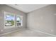 Bright bedroom featuring a neutral color palette and a view of the outdoors at 61 Okeechobee Way, Braselton, GA 30548