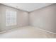 Well-lit bedroom with a large window, ready for flooring and personalization at 61 Okeechobee Way, Braselton, GA 30548