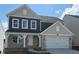 Beautiful two-story home with brick accents, neutral siding, covered entry, and a two-car garage at 61 Okeechobee Way, Braselton, GA 30548