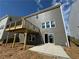 View of back of the house featuring a wooden deck, walk out basement, and neutral siding at 61 Okeechobee Way, Braselton, GA 30548
