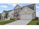 Charming home with a two-car garage, brick accents and a well-manicured lawn at 61 Okeechobee Way, Braselton, GA 30548