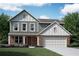 Charming two-story home with a brick and siding exterior, attached garage, and well-manicured lawn at 61 Okeechobee Way, Braselton, GA 30548