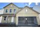 Charming new construction home showcasing a two-car garage and inviting front porch at 61 Okeechobee Way, Braselton, GA 30548