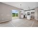 Kitchen and dining area with white cabinets, kitchen island, and a sliding door to the outdoors at 61 Okeechobee Way, Braselton, GA 30548